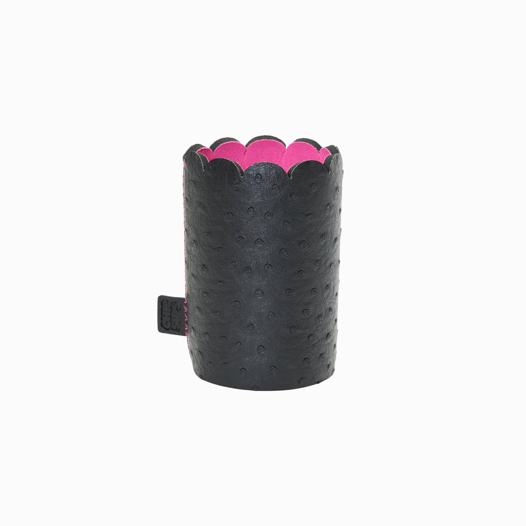 Can Couture vegan leather can sleeve in Edie black ostrich, empty, showing the scalloped edge, pink lining and brand tab