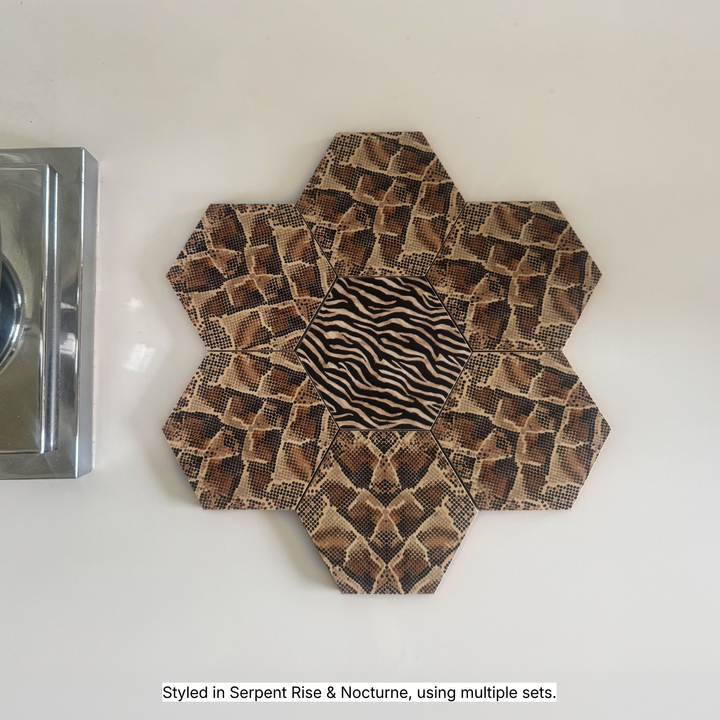 Hexagonal coasters in Serpent Rise snake print and Nocturne zebra print tessellated into a flower shape on a white surface