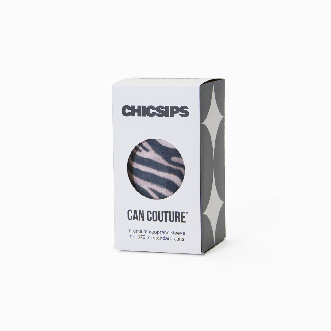 White Chic Sips Can Couture product packaging box with black text and circular cut-out showing Nocturne zebra print can sleeve design