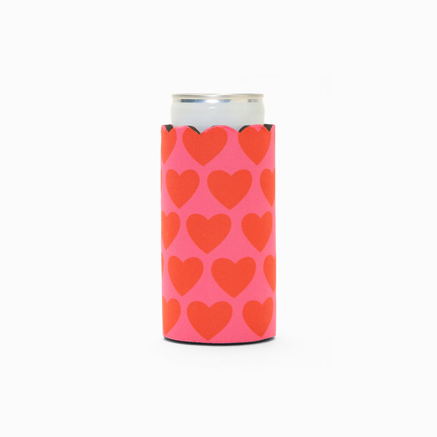 Pink and red heart print can sleeve with scalloped edge, holding a can