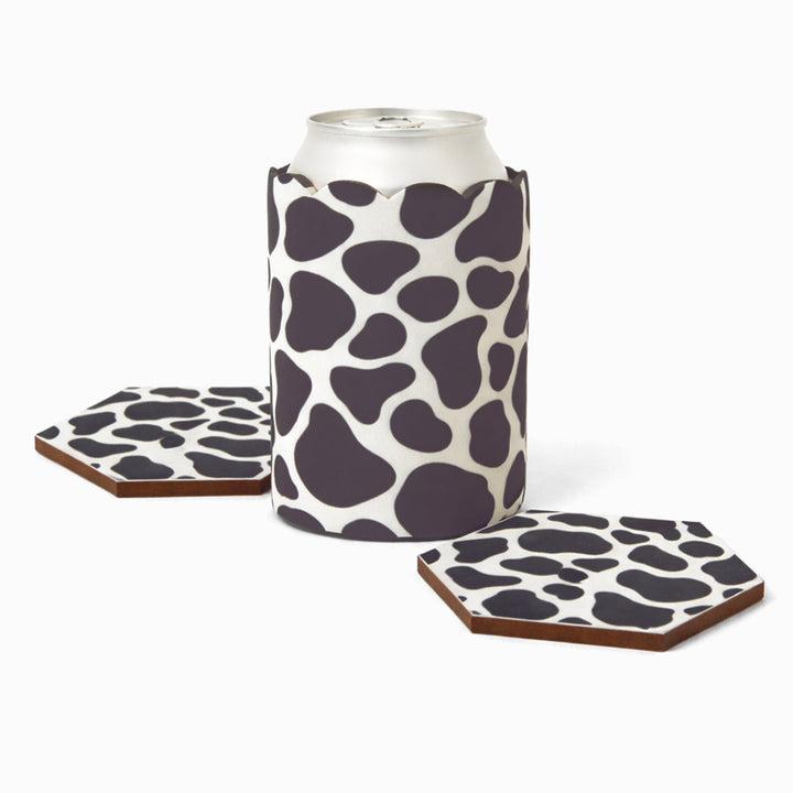 Black and white cow print can sleeve with beverage can and two matching hexagonal coasters