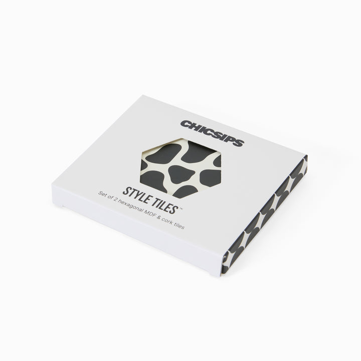 Style Tiles packaging box with hexagon window showing cow print coaster