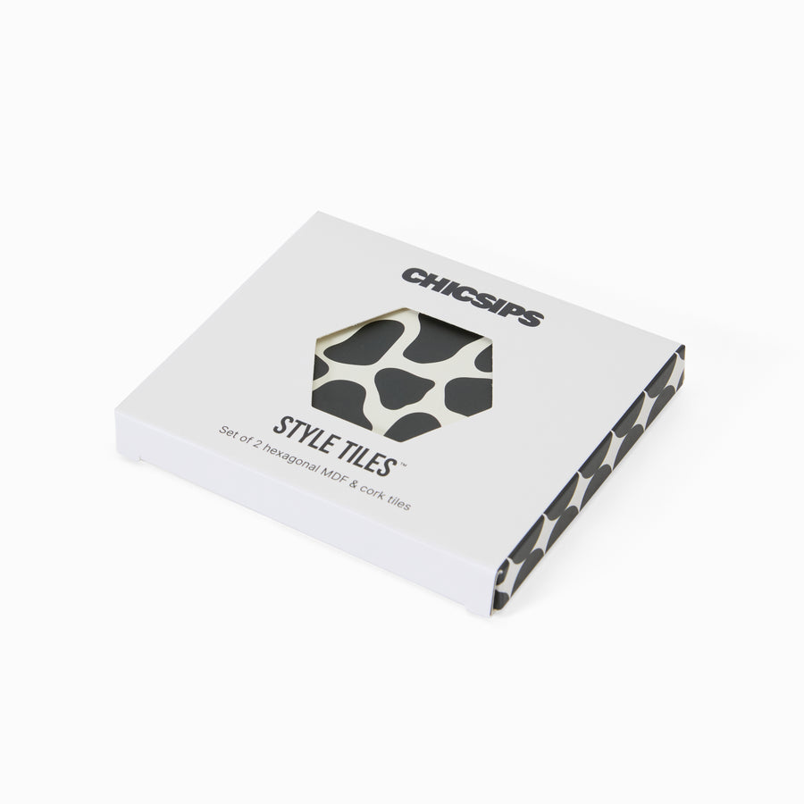 Style Tiles packaging box with hexagon window showing cow print coaster