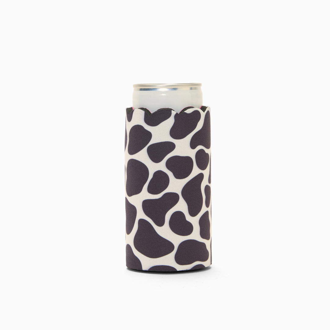 Cow print can sleeve with scalloped edge, holding a can