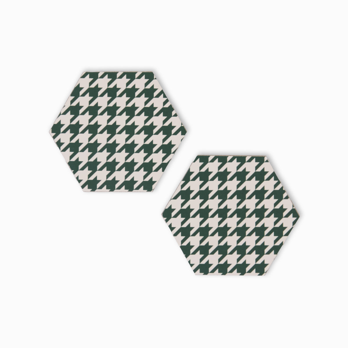 Two green and cream houndstooth print hexagonal coasters