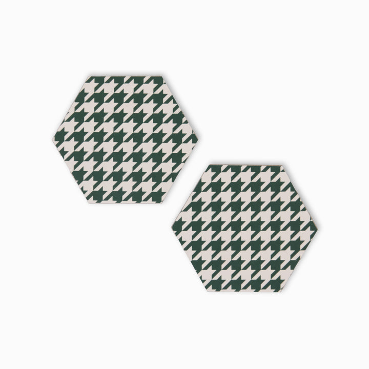 Two green and cream houndstooth print hexagonal coasters
