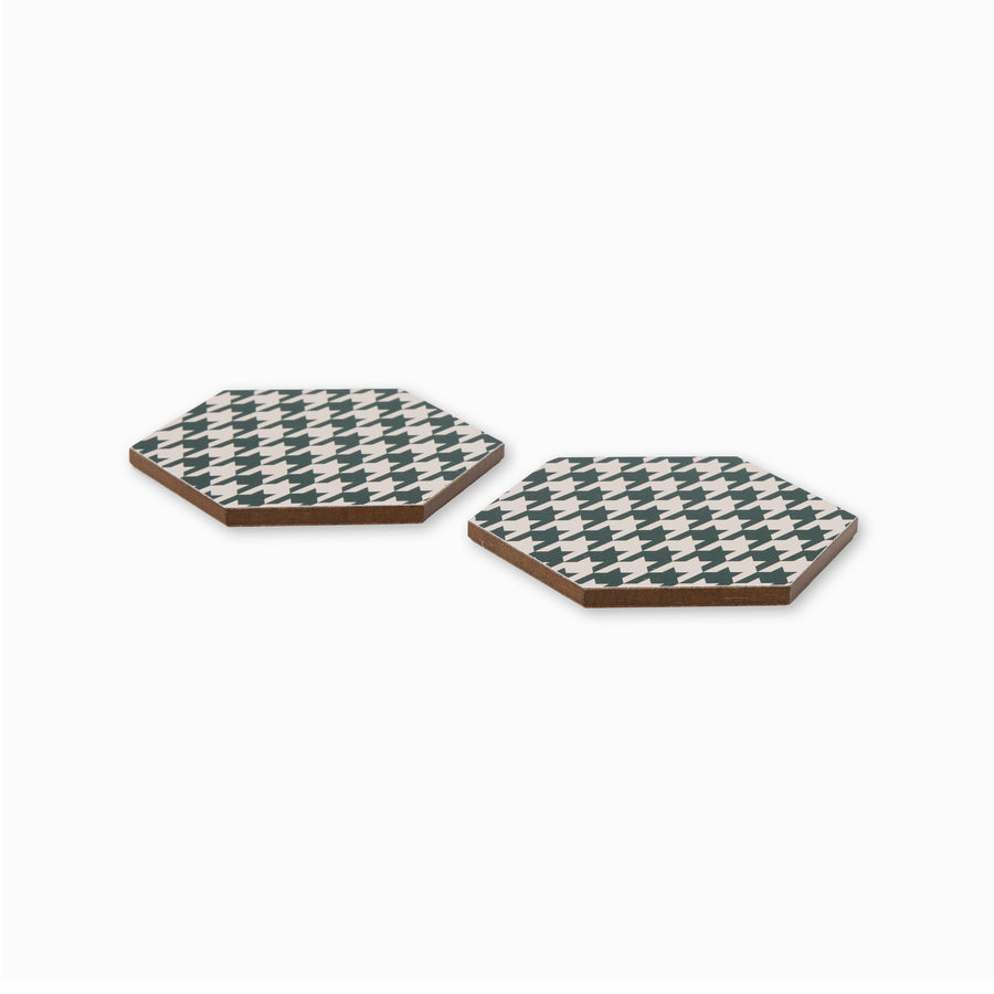 Two green and cream houndstooth print hexagonal coasters shown from side angle