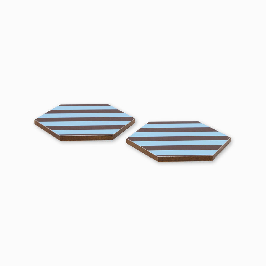 Two blue and chocolate stripe print hexagonal coasters shown from side angle