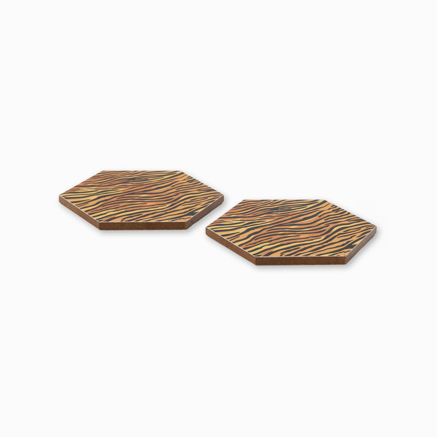 Two tiger print hexagonal coasters shown from side angle