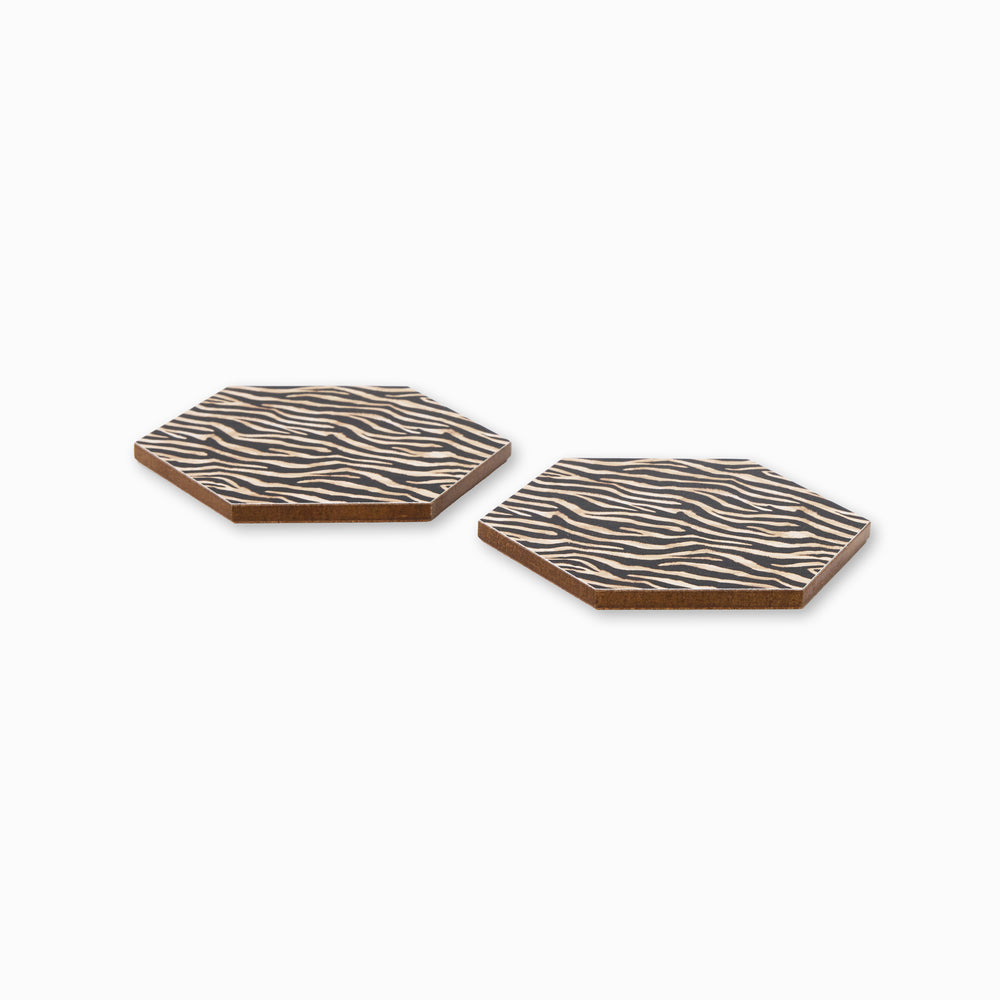 Two zebra print hexagonal coasters shown from side angle