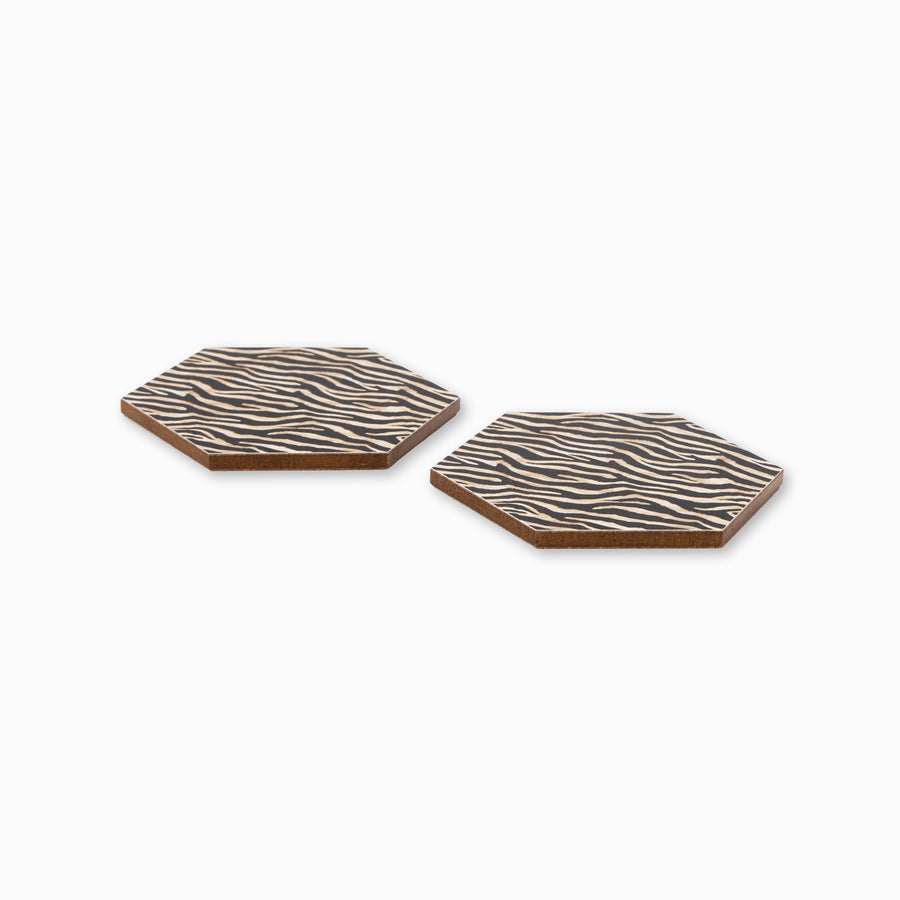 Two zebra print hexagonal coasters shown from side angle